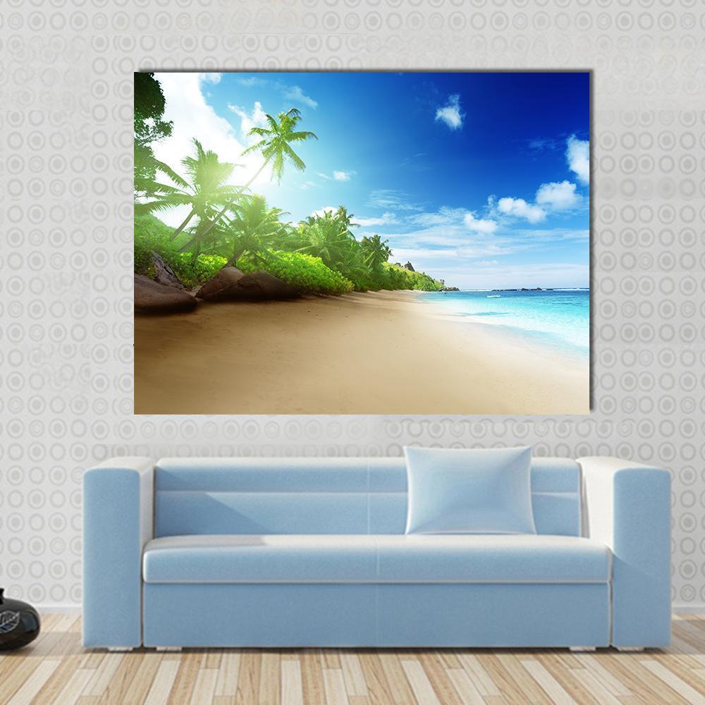 Sunset on Mahe Island Beach Canvas Wall Art in beige, green and blue, single panel hung on a wall