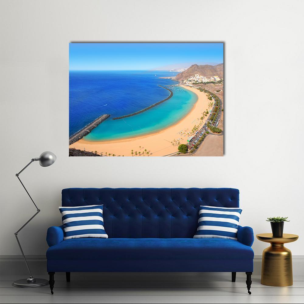 Aerial Beach View with Breakwater Canvas Wall Art in beige and blue, single panel hung on a wall