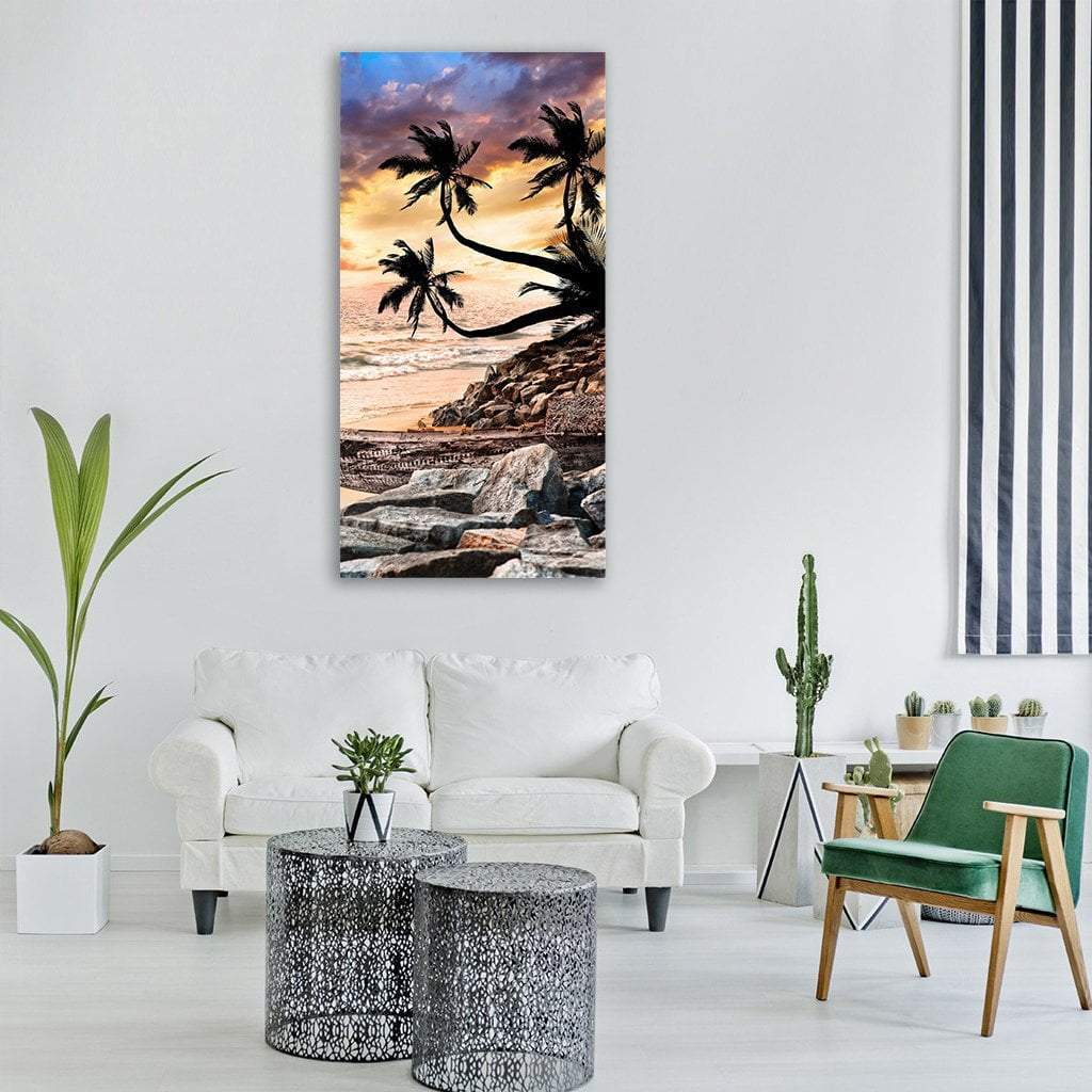 Tropical Sunset Beach with Palm Trees Vertical Canvas Wall Art in gray, orange and purple, single vertical panel hung on a wall