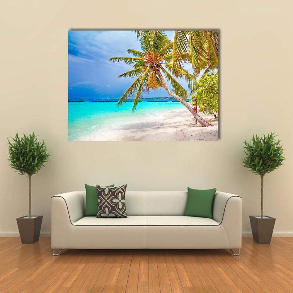 Tropical Beach with Palm Tree Canvas Wall Art in white, green and blue, single panel hung on a wall