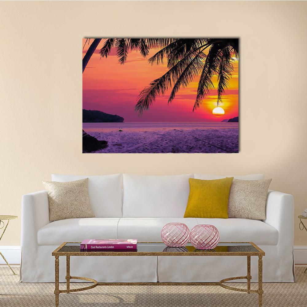 Coconut Tree at Sunset Beach Canvas Wall Art in orange, purple and pink, single panel hung on a wall