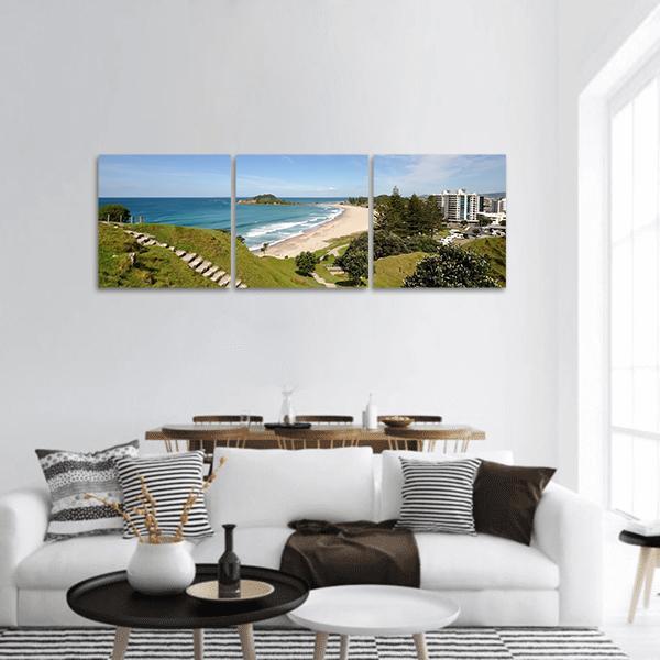 Mount Maunganui Beach View with Stone Steps Panoramic Canvas Wall Art in beige, green and blue, hung on a wall
