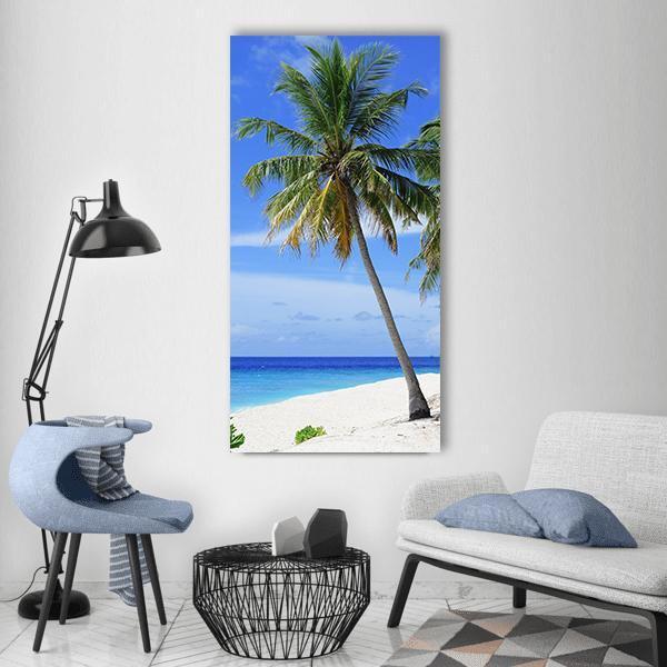 Palm Tree Beach in Maldives Vertical Canvas Wall Art in white, green and blue, single vertical panel hung on a wall
