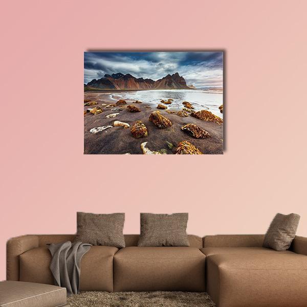 Wet Sand Beach with Jagged Mountains Canvas Wall Art in gray, brown and blue, single panel hung on a wall