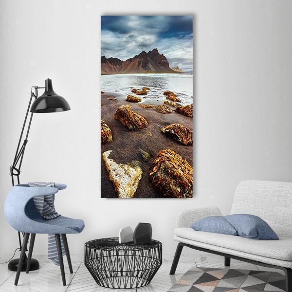 Vestrahorn Black Sand Beach Photograph Vertical Canvas Wall Art in black, gray and brown, single vertical panel hung on a wall