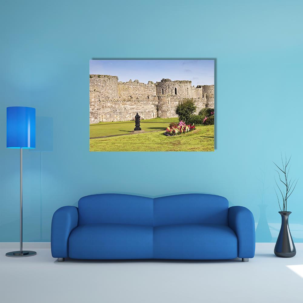 Beaumaris Castle Courtyard with Statue and Flowers Canvas Wall Art in gray, green and blue, single panel hung on a wall