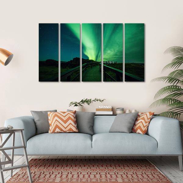 Aurora Borealis Over Iceland Boardwalk Canvas Wall Art in black and green, single panel hung on a wall