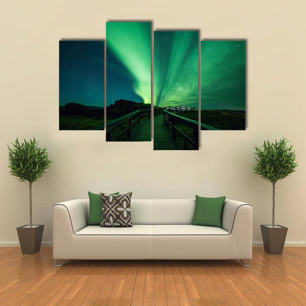 Aurora Borealis in Iceland Canvas Wall Art in black and green, 3 panel horizontal set hung on a wall