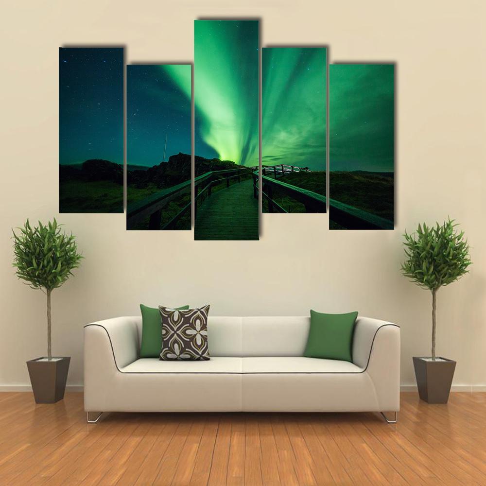 Aurora Borealis in Iceland Canvas Wall Art in black and green, 3 panel horizontal set hung on a wall