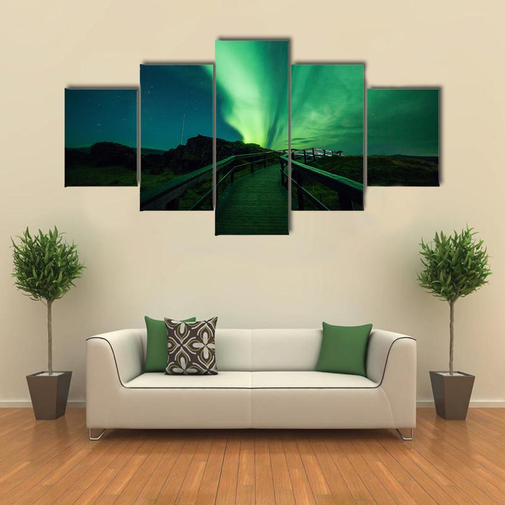 Aurora Borealis in Iceland Canvas Wall Art in black and green, 3 panel horizontal set hung on a wall