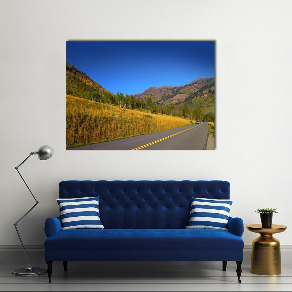 Scenic Autumn Drive in Colorado Canvas Wall Art in gray, yellow and blue, single panel hung on a wall
