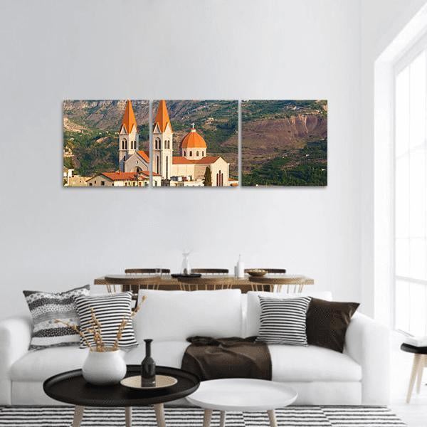Church in Bsharri Panoramic Canvas Wall Art in white, orange and green, hung on a wall