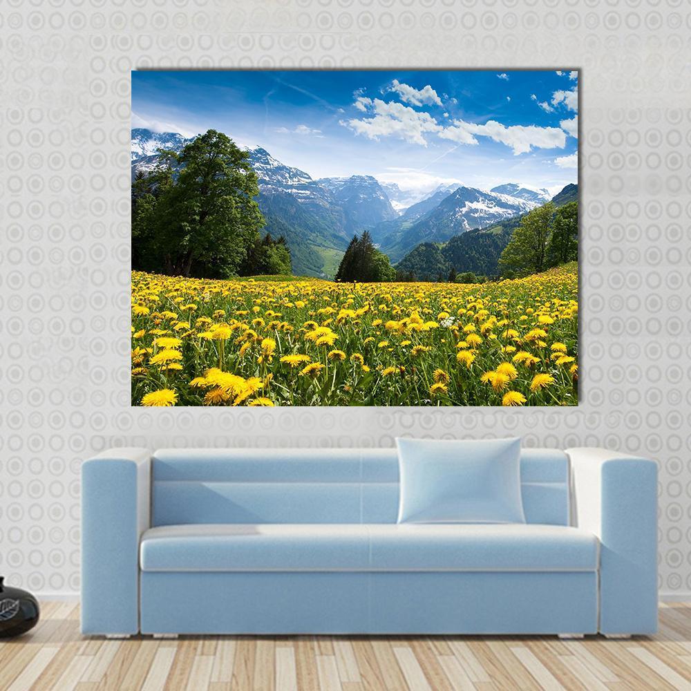 Blossoming Field Switzerland Canvas Wall Art in yellow, green and blue, single panel hung on a wall