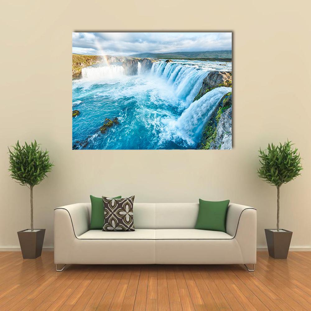 Godafoss Waterfall with Rainbow Canvas Wall Art in white, brown and blue, single panel hung on a wall