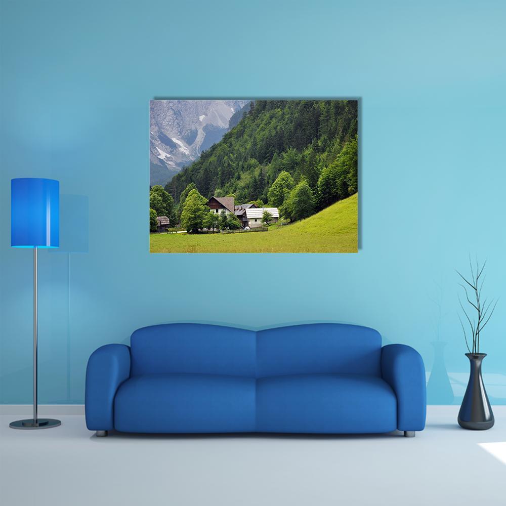 Two Houses in Mountain Valley Canvas Wall Art in gray and green, single panel hung on a wall