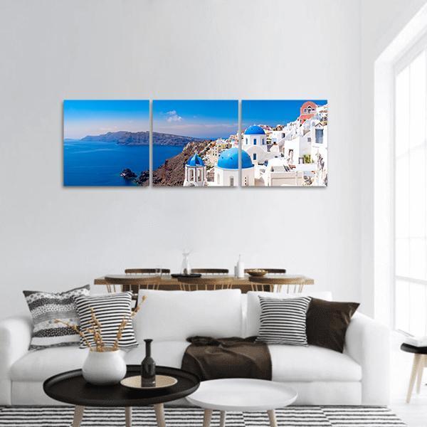 Oia Santorini Village Coastline Panoramic Canvas Wall Art in white and blue, hung on a wall