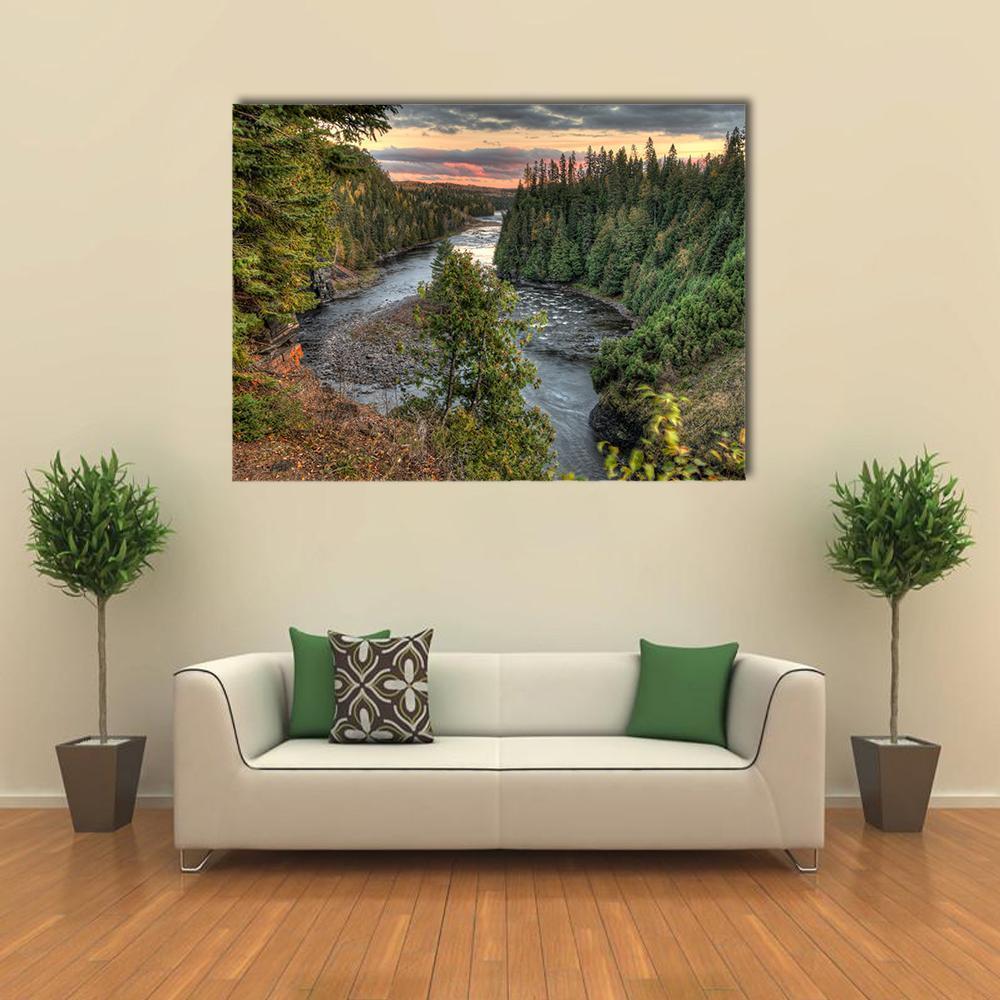 Winding River Through Pine Cliffs at Sunset Canvas Wall Art in gray, orange and green, single panel hung on a wall