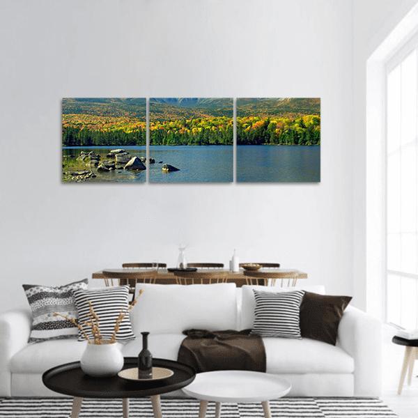 Mt. Katahdin Lake in Autumn Panoramic Canvas Wall Art in yellow, green and blue, hung on a wall