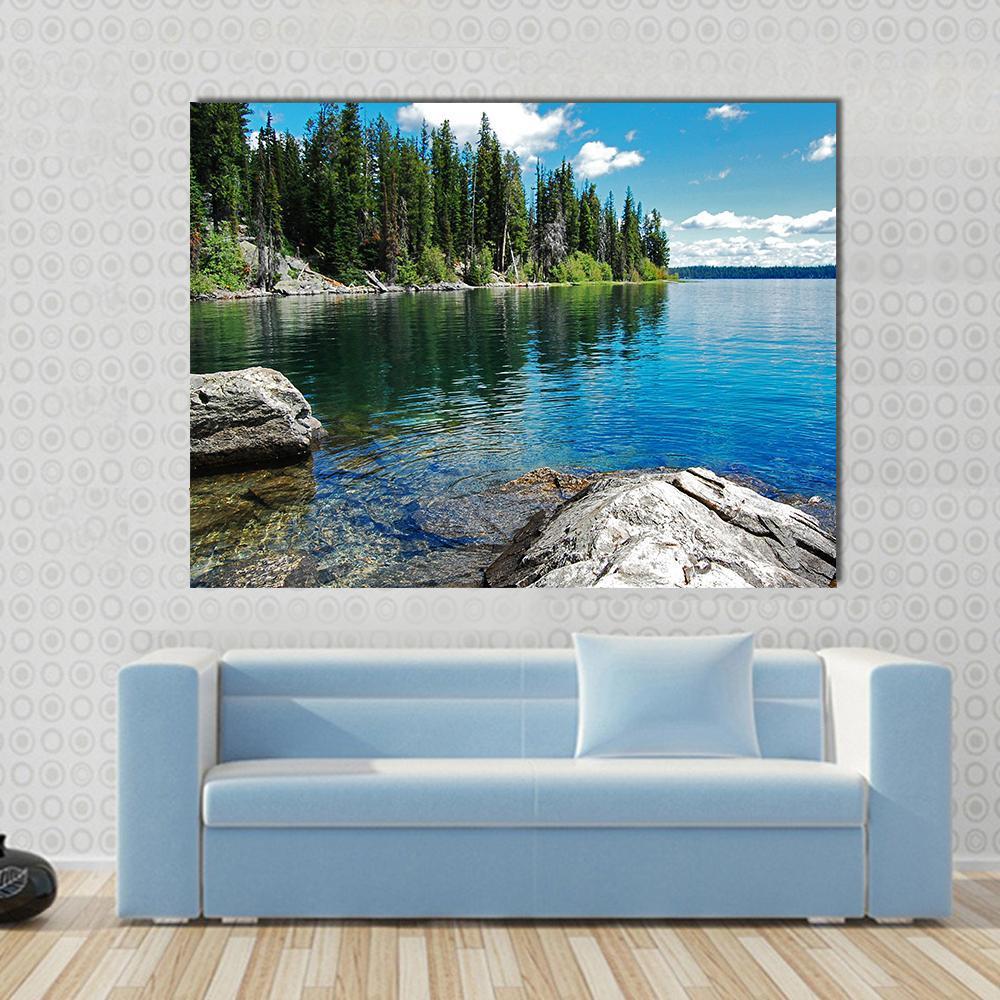 Serene Landscape with Lake Canvas Wall Art in green and blue, single panel hung on a wall