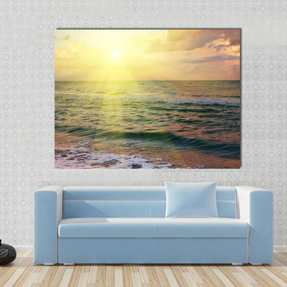 Beautiful Sea Sunset Canvas Wall Art in orange, yellow and blue, single panel hung on a wall
