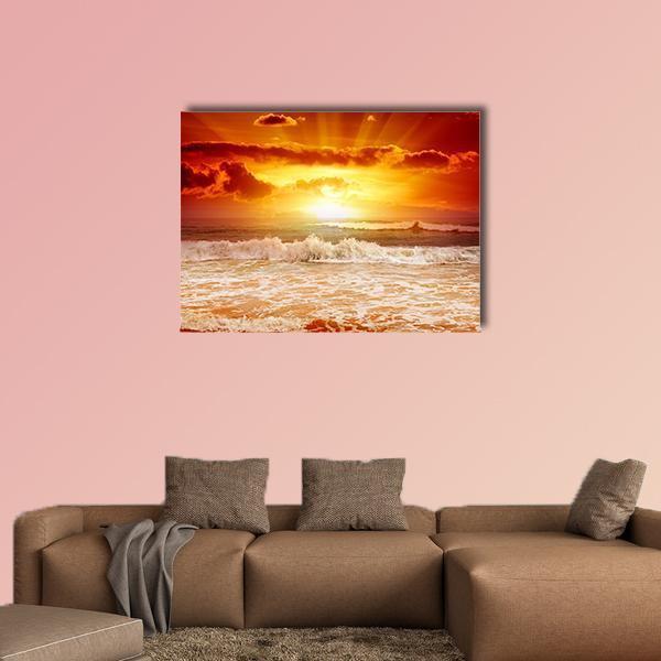 Sunset Above the Sea Canvas Wall Art in red, orange and yellow, single panel hung on a wall