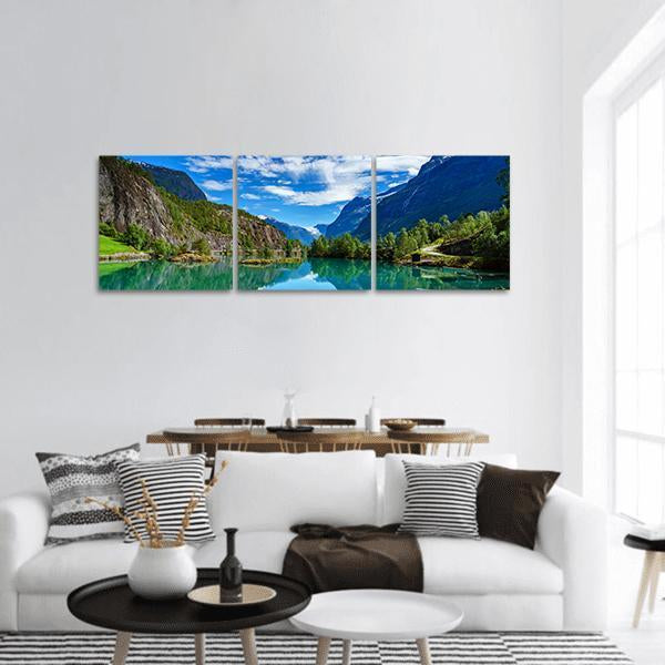 Norway Fjord with Mountain Reflections Panoramic Canvas Wall Art in green and blue, hung on a wall