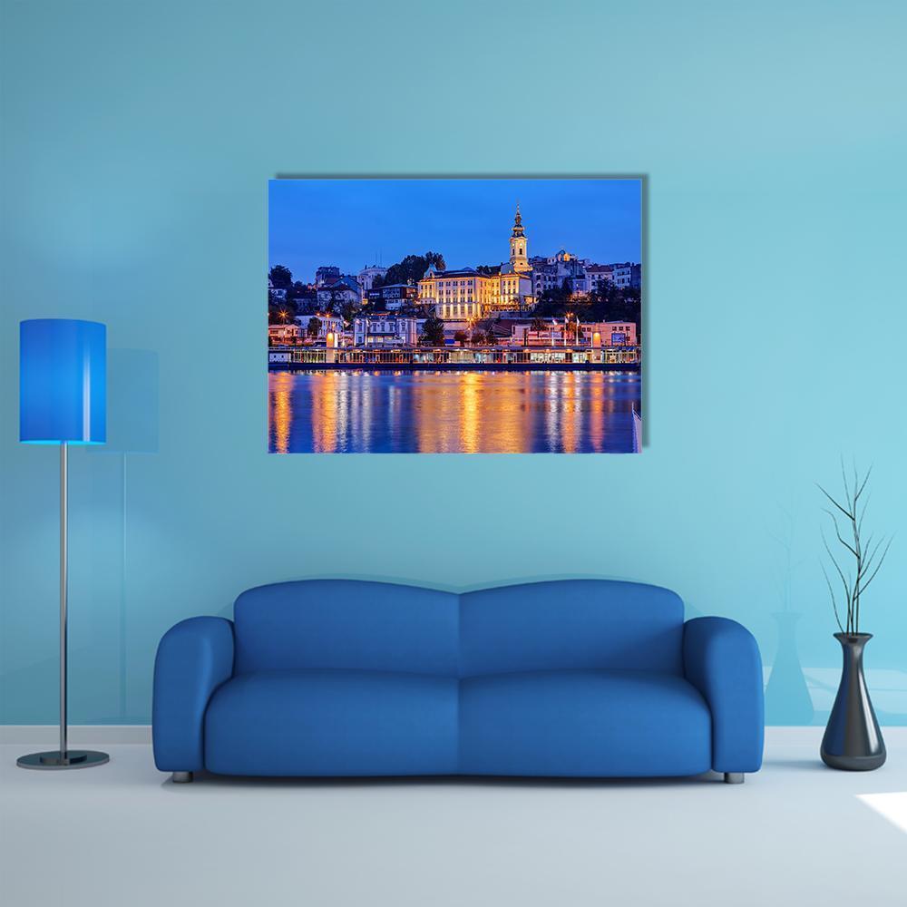 Belgrade Riverfront at Night Canvas Wall Art in orange, yellow and blue, single panel hung on a wall