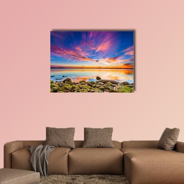 Benbrook Lake Sunset Reflection Canvas Wall Art in orange, blue and pink, single panel hung on a wall