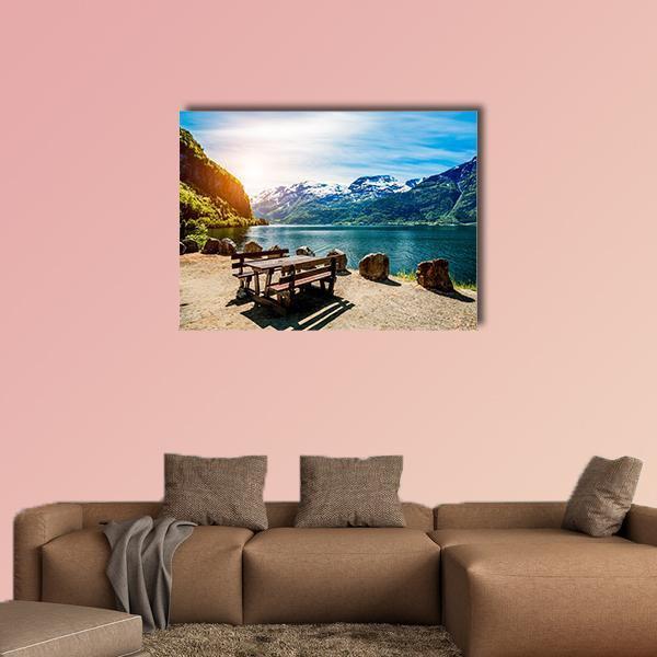 Bench Near Lake Canvas Wall Art in brown, green and blue, single panel hung on a wall