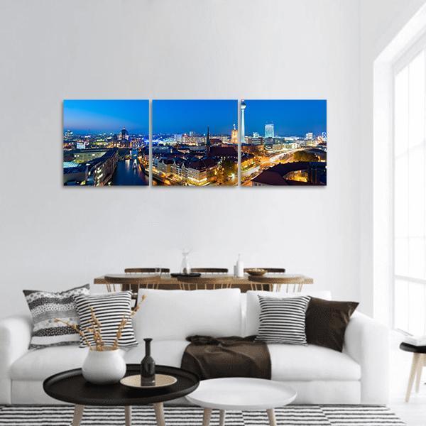 Berlin Skyline Featuring Tv Tower Panoramic Canvas Wall Art in black, yellow and blue, hung on a wall