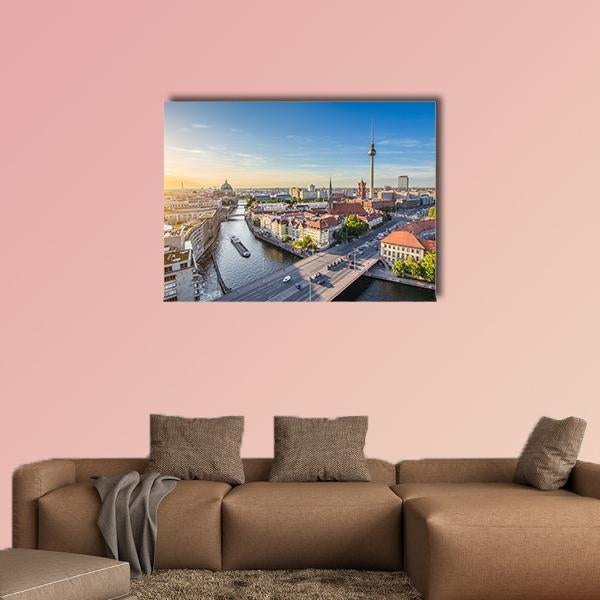 Berlin Skyline at Golden Hour Canvas Wall Art in orange, yellow and blue, single panel hung on a wall