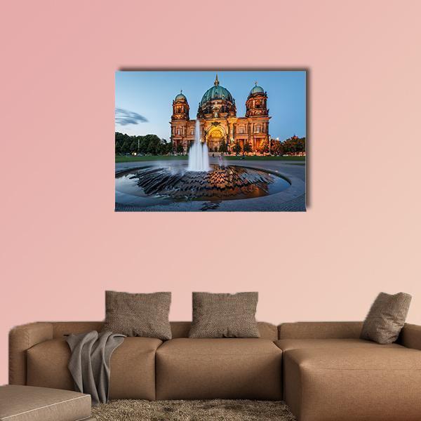 Berlin Cathedral with Illuminated Fountain Canvas Wall Art in gray, orange and blue, single panel hung on a wall