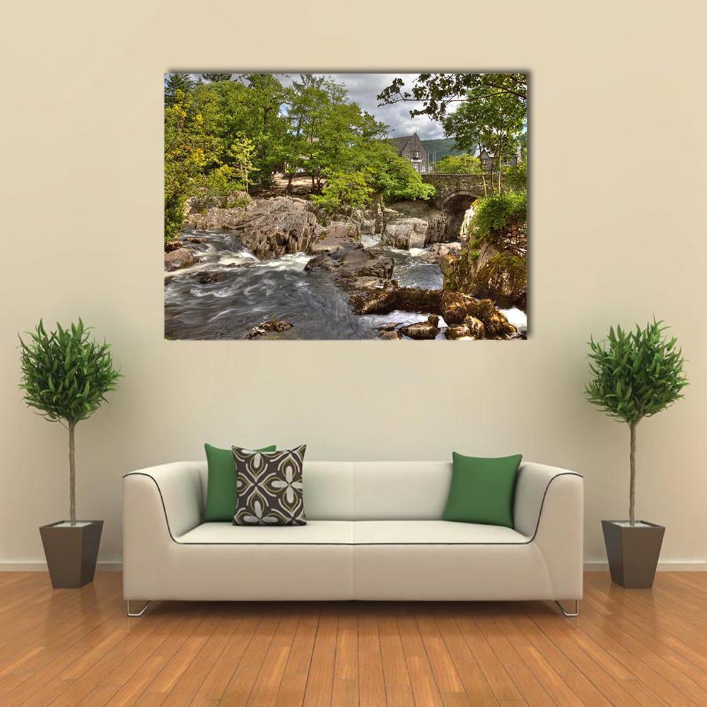 Stone Bridge Over River Rapids Canvas Wall Art in gray, brown and green, single panel hung on a wall