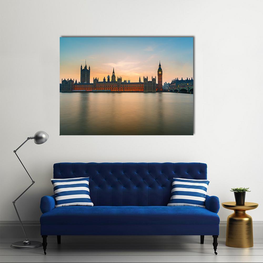 Big Ben at Dusk Over the Thames Canvas Wall Art in orange, yellow and blue, single panel hung on a wall