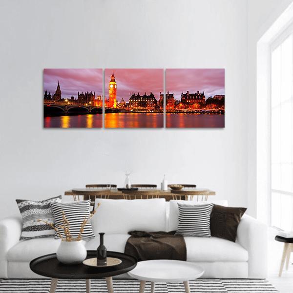 Big Ben and Westminster Bridge at Night Panoramic Canvas Wall Art in black, orange and pink, hung on a wall