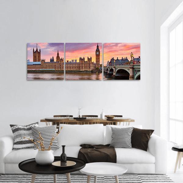 Westminster and Big Ben on the River Thames Panoramic Canvas Wall Art in orange, blue and pink, hung on a wall