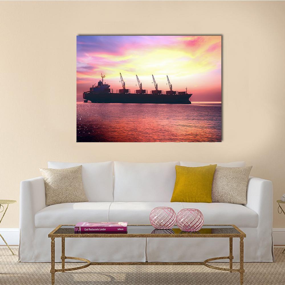 International Cargo Ship at Sunset Canvas Wall Art in orange, purple and pink, single panel hung on a wall