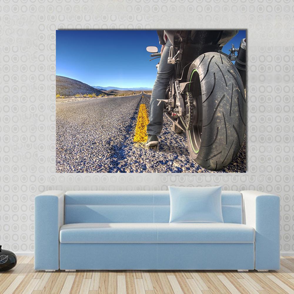 Motorcycle on Road Canvas Wall Art in black, gray and blue, single panel hung on a wall