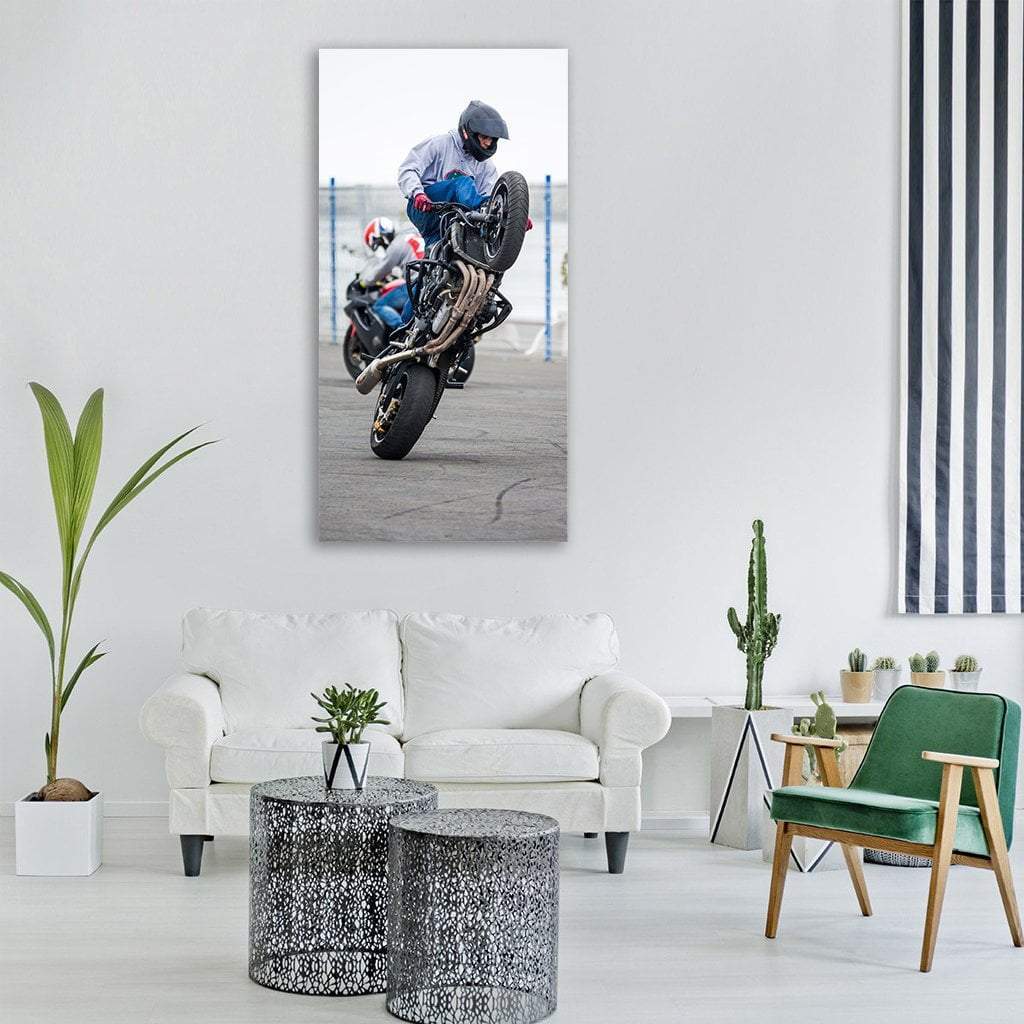 Motorcyclist Performing Wheelie Vertical Canvas Wall Art in black, white and gray, single vertical panel hung on a wall