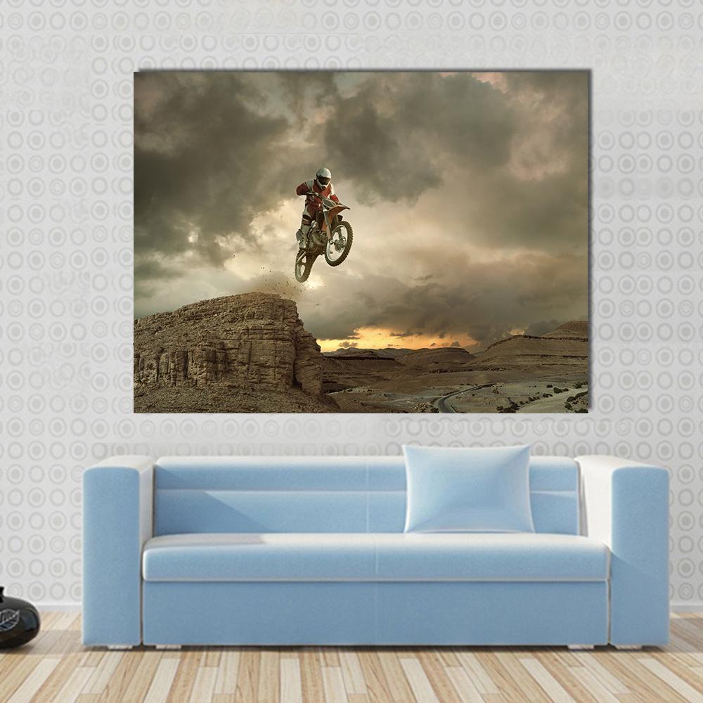 Motocross Rider Mid-air Over Desert Canyon Canvas Wall Art in gray, beige and brown, single panel hung on a wall
