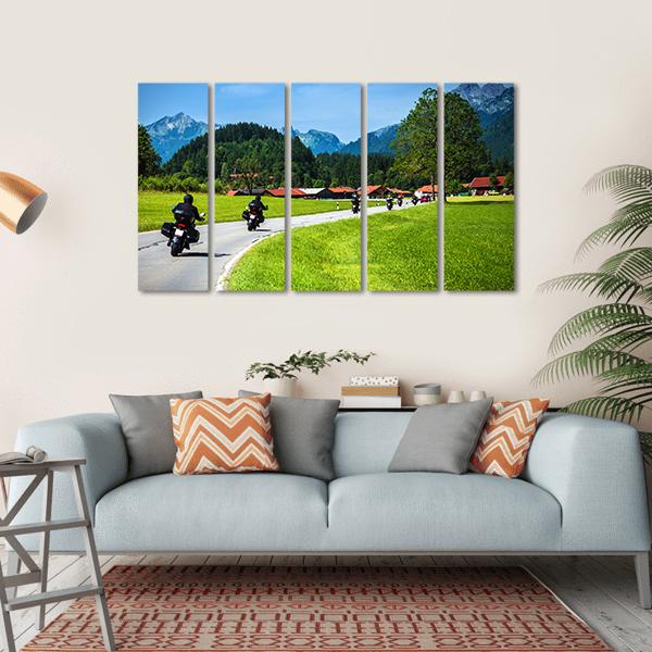 Motorcyclists on Winding Mountain Road Canvas Wall Art in gray, green and blue, hung on a wall