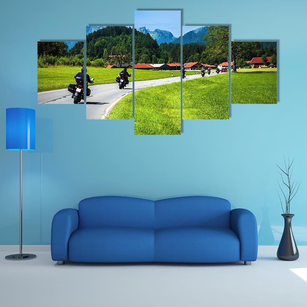 Bikers on Mountainous Road Canvas Wall Art in gray, green and blue, 5 panel Star layout hung on a wall