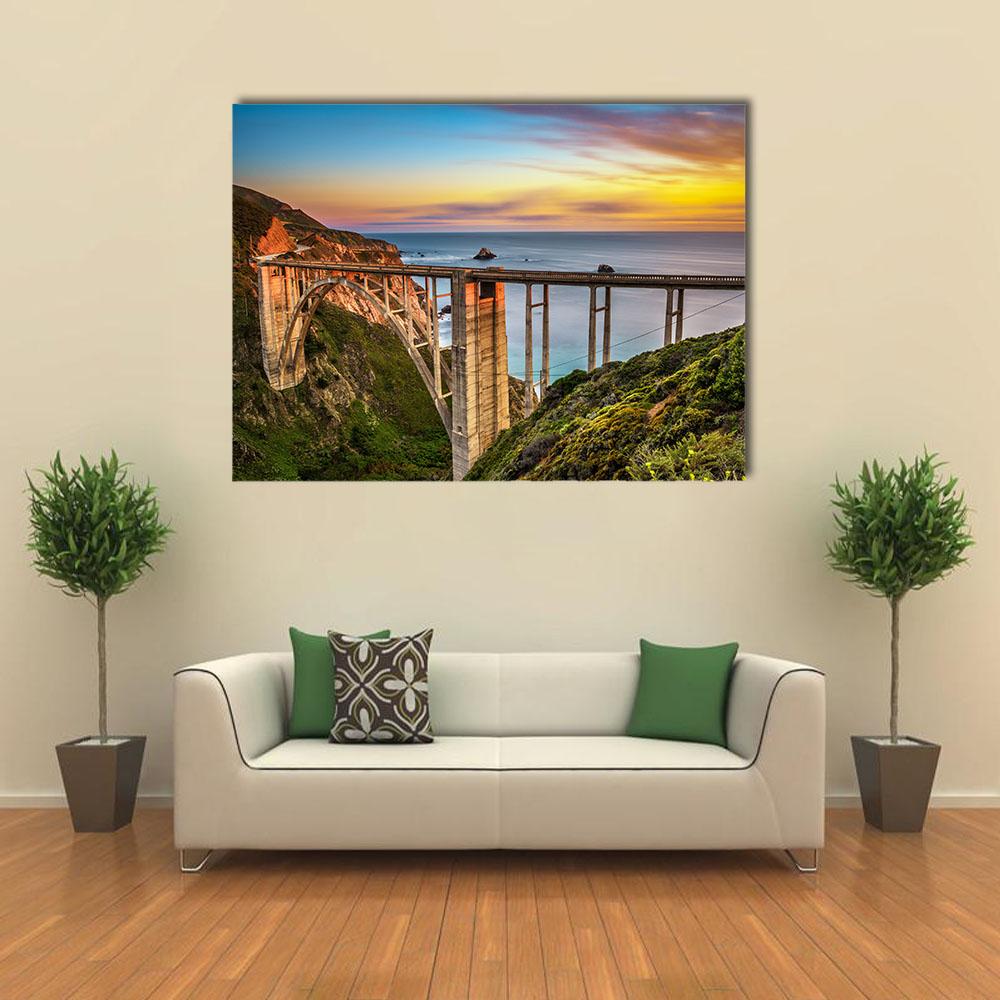Bixby Creek Bridge at Golden Hour Canvas Wall Art in orange, green and blue, single panel hung on a wall