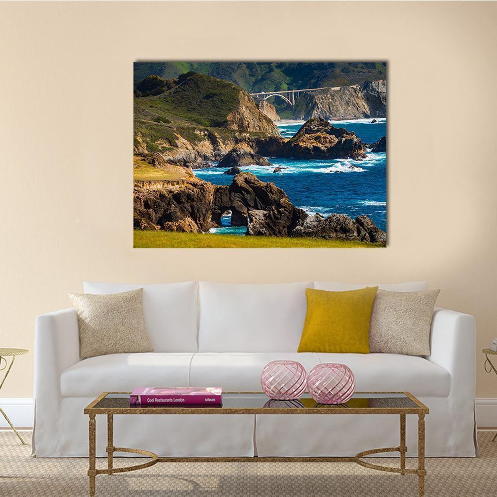 Bixby Creek Bridge and Coastal Rock Arch Canvas Wall Art in brown, green and blue, single panel hung on a wall