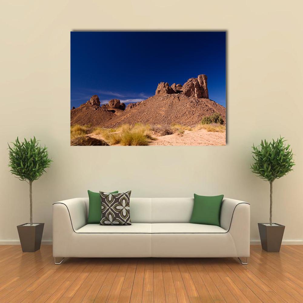Bizarre Rock Formation in Algeria Canvas Wall Art in beige, brown and blue, single panel hung on a wall