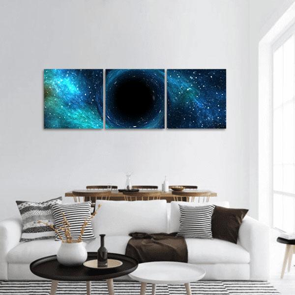 Black Hole Over Star Field Panoramic Canvas Wall Art in black and blue, hung on a wall