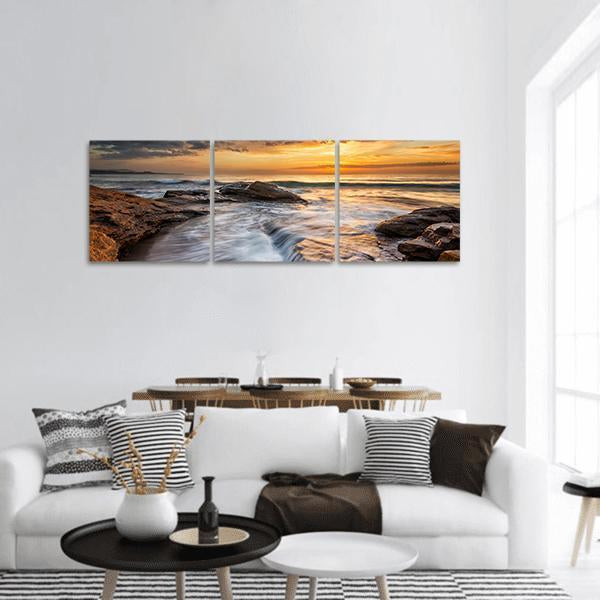 Black Sea Coast at Sunset Panoramic Canvas Wall Art in brown, orange and blue, hung on a wall