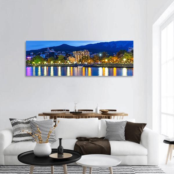 Yalta Night Waterfront with Mountain Silhouettes Panoramic Canvas Wall Art in black, yellow and blue, single panel hung on a wall