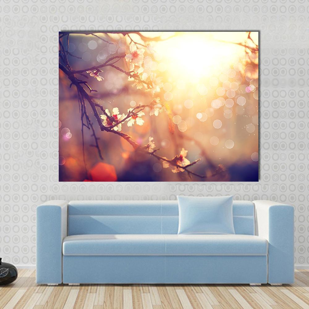 Blooming Tree with Sunlight Canvas Wall Art in brown, yellow and pink, single panel hung on a wall