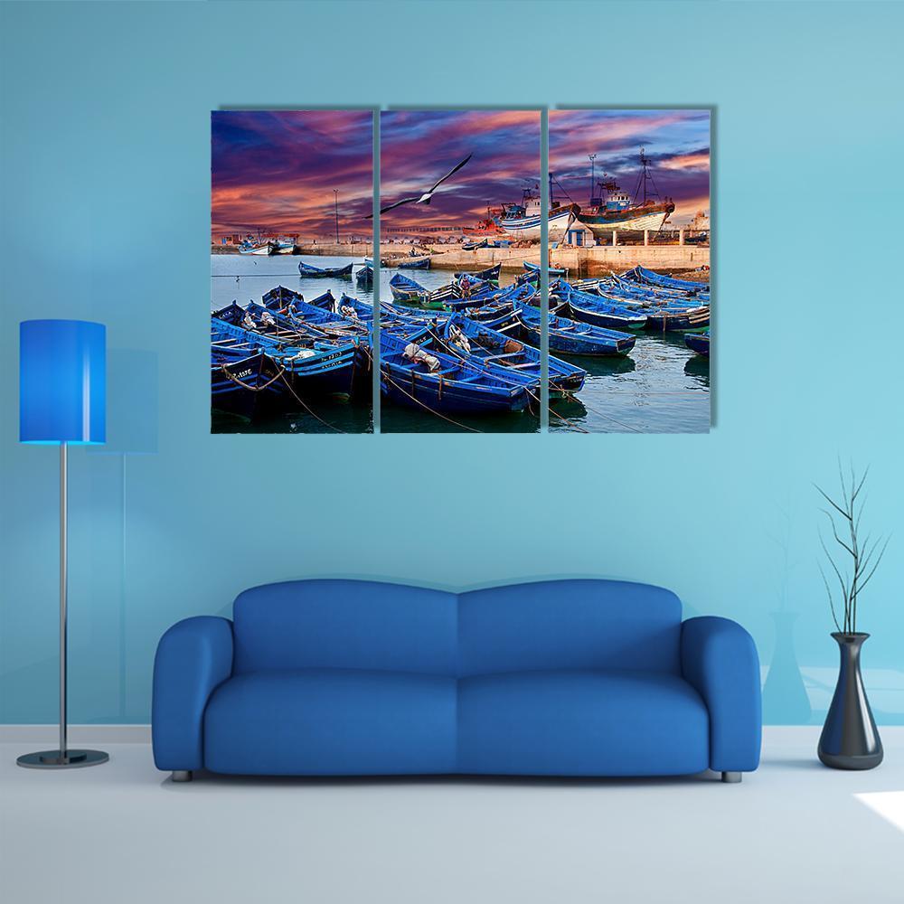 Blue Fishing Boats in Morocco Canvas Wall Art in orange, blue and purple, 3 panel horizontal set hung on a wall